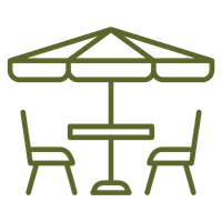 A table with two chairs under a large umbrella.